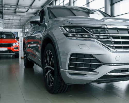 front view of modern new silver colored car andRabljena vozila | Preverjena ponudba | Avto Wikra red one behind