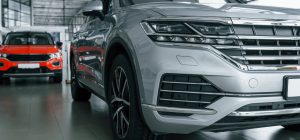 front view of modern new silver colored car andRabljena vozila | Preverjena ponudba | Avto Wikra red one behind